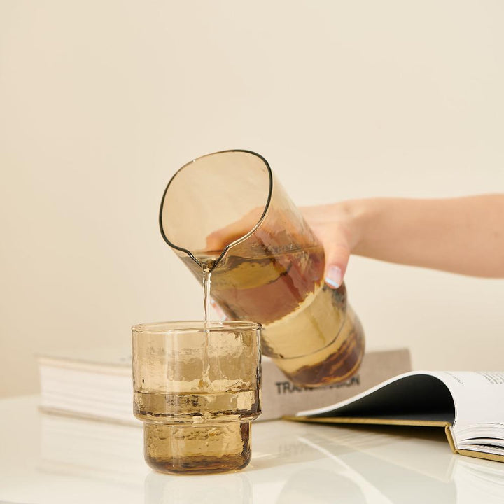 Brown handmade glass carafe and matching stackable glass