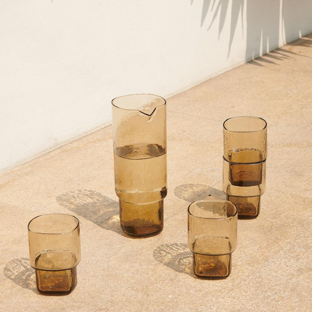 Slim stackable brown drinking glasses with matching glass carafe