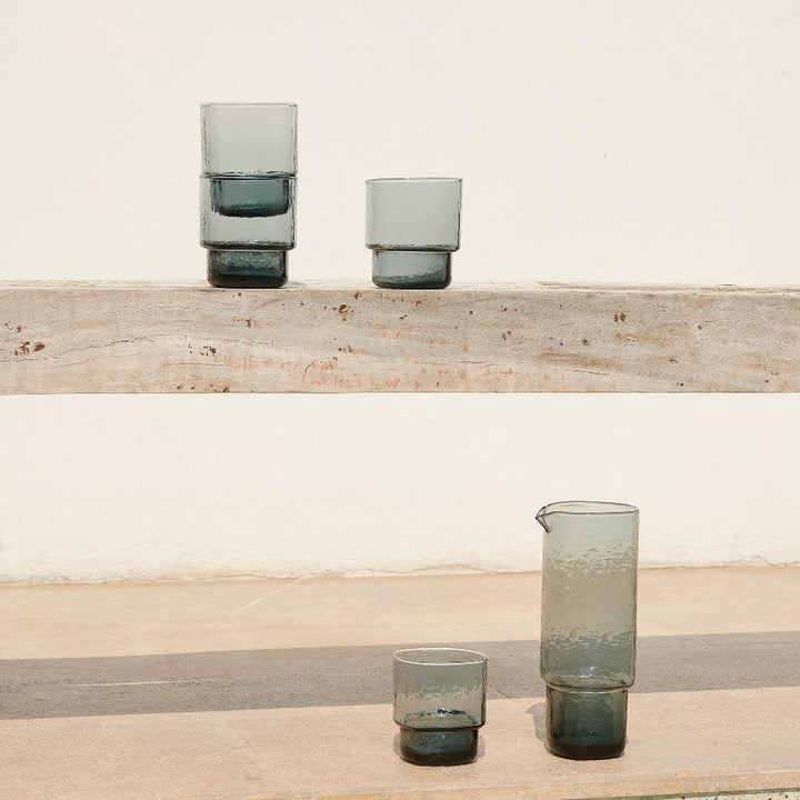 Handmade glass carafe and matching stackable glasses with hammered effect smoke grey