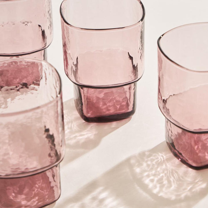 Close up of hammered drinking glass in pastel pink