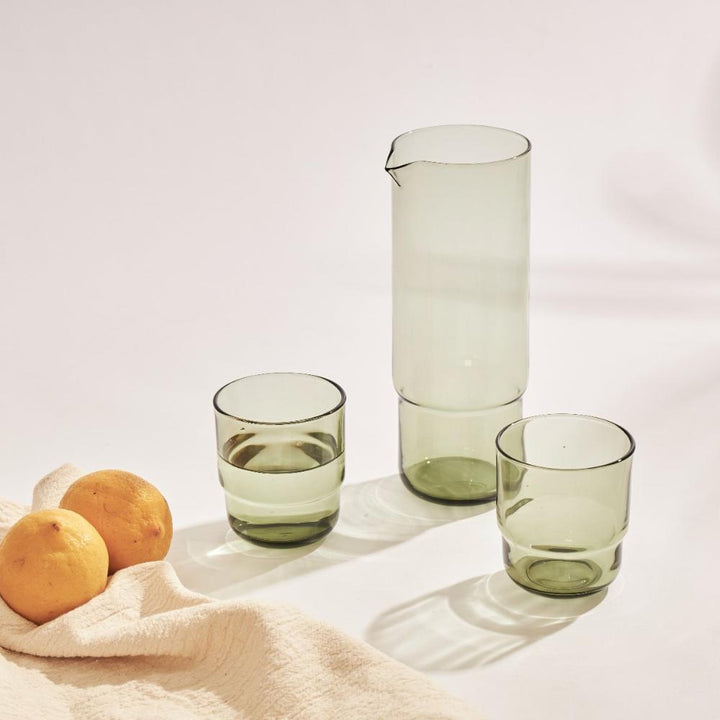 Olive green cylindrical glass carafe and matching drinking glasses