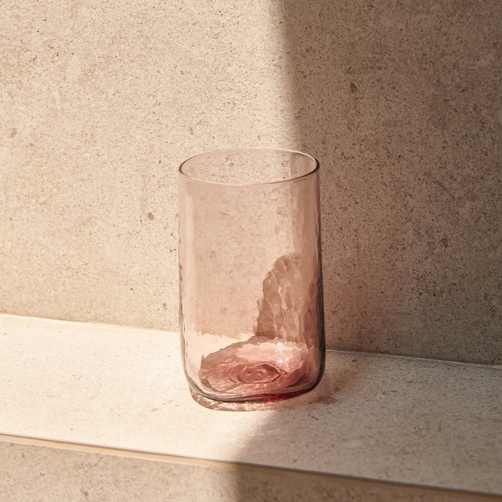 Tall drinking glass pastel pink with hammered effect