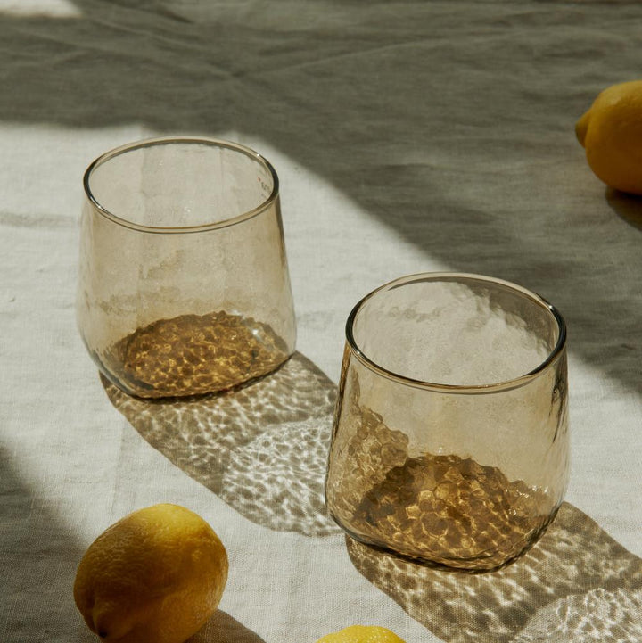 Uniquely shaped brown handmade drinking glasses with hammered texture